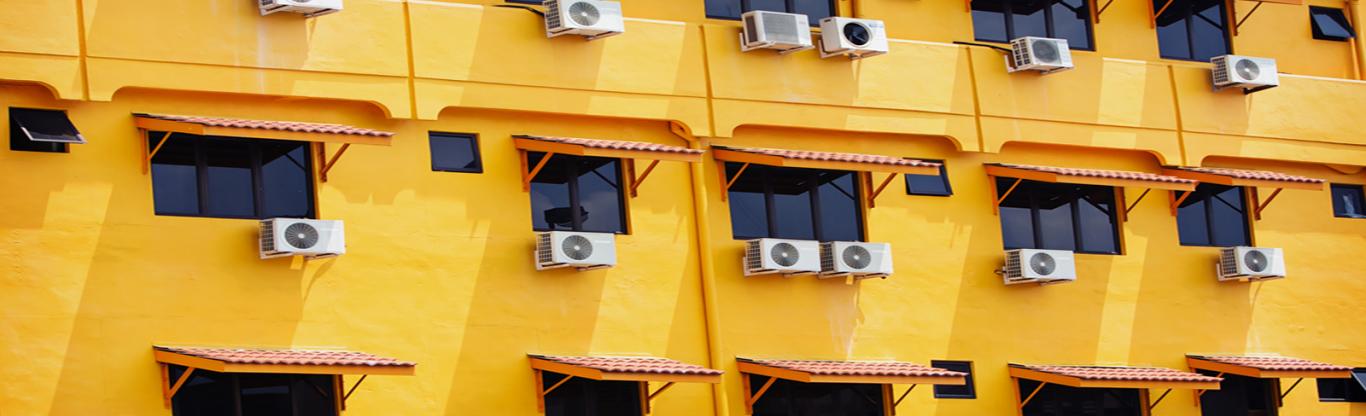 building and air conditioner units hanging from windows